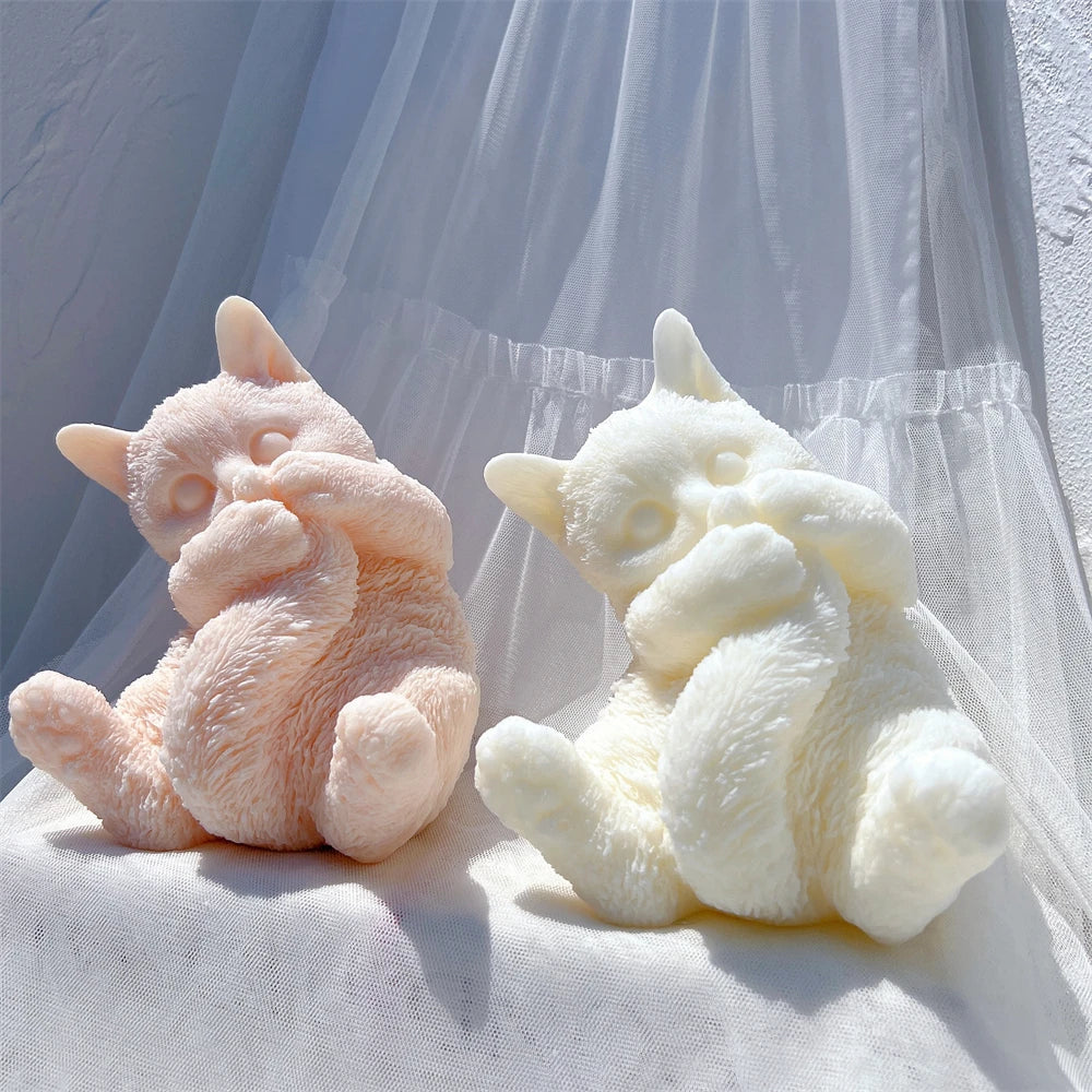 Cat candle castings with textured fur and rounded bodies