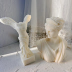 Winged Victory sculpture beside the draped Artemis bust