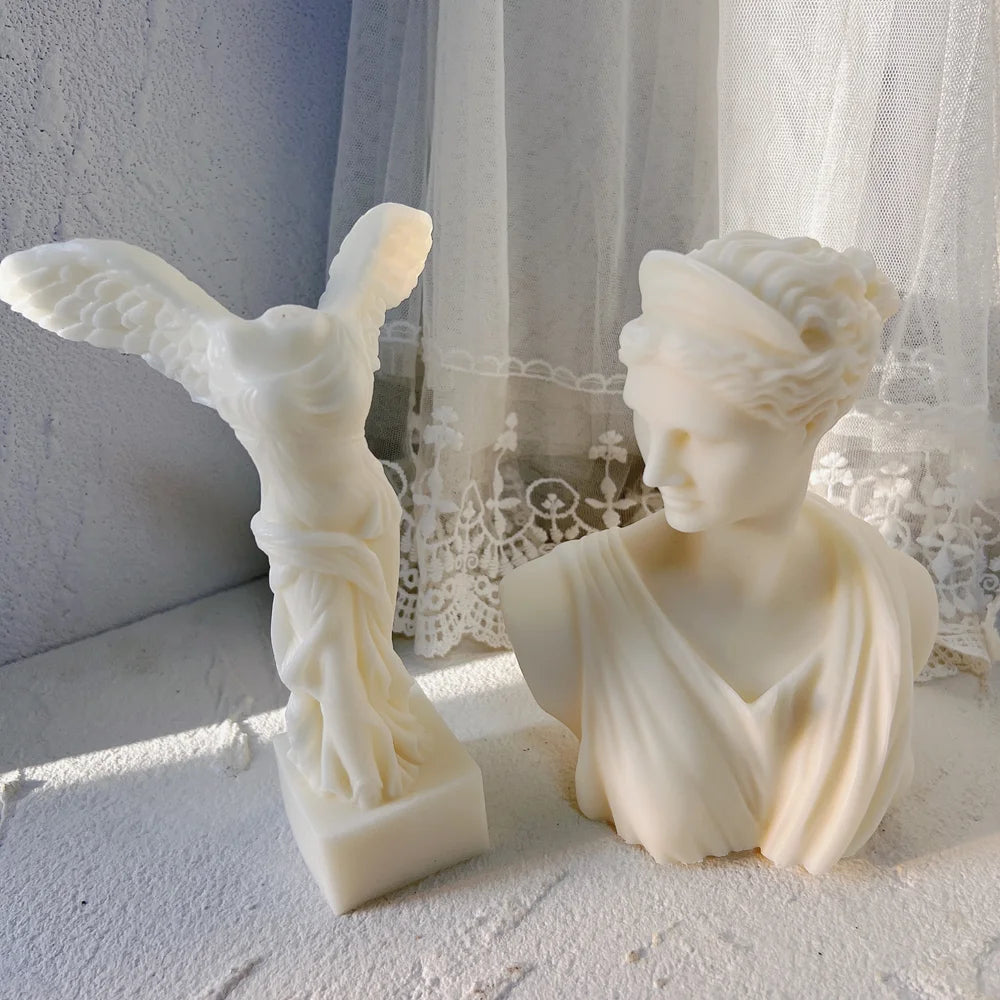 Winged Victory sculpture beside the draped Artemis bust