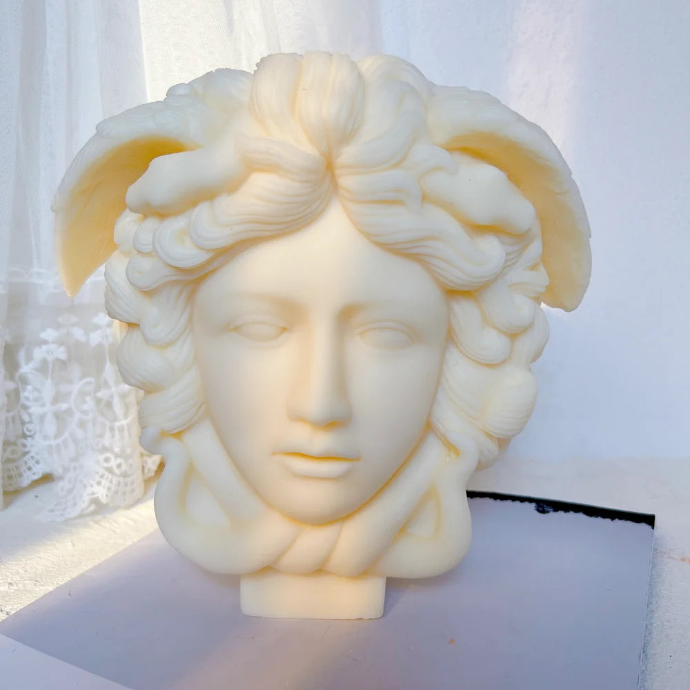 Front view of sculpted Medusa head with crown details