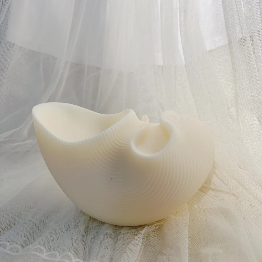 White abstract vessel casting with a broad flared opening and smaller round recess