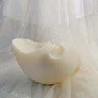 White abstract vessel casting with a broad flared opening and smaller round recess