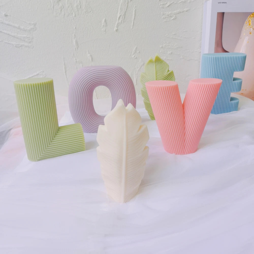 Pastel LOVE letter castings with a decorative leaf prop