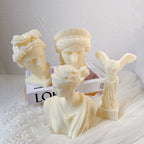 Four cream classical sculptures with detailed hair, drapery and wings