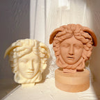 Ivory and terracotta Medusa face castings on display