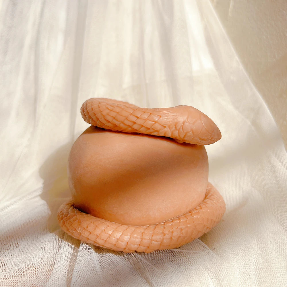 Snake-and-apple sculpture viewed from the side