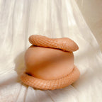 Snake-and-apple sculpture viewed from the side