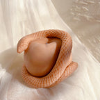 Angled view of the snake's head above the apple