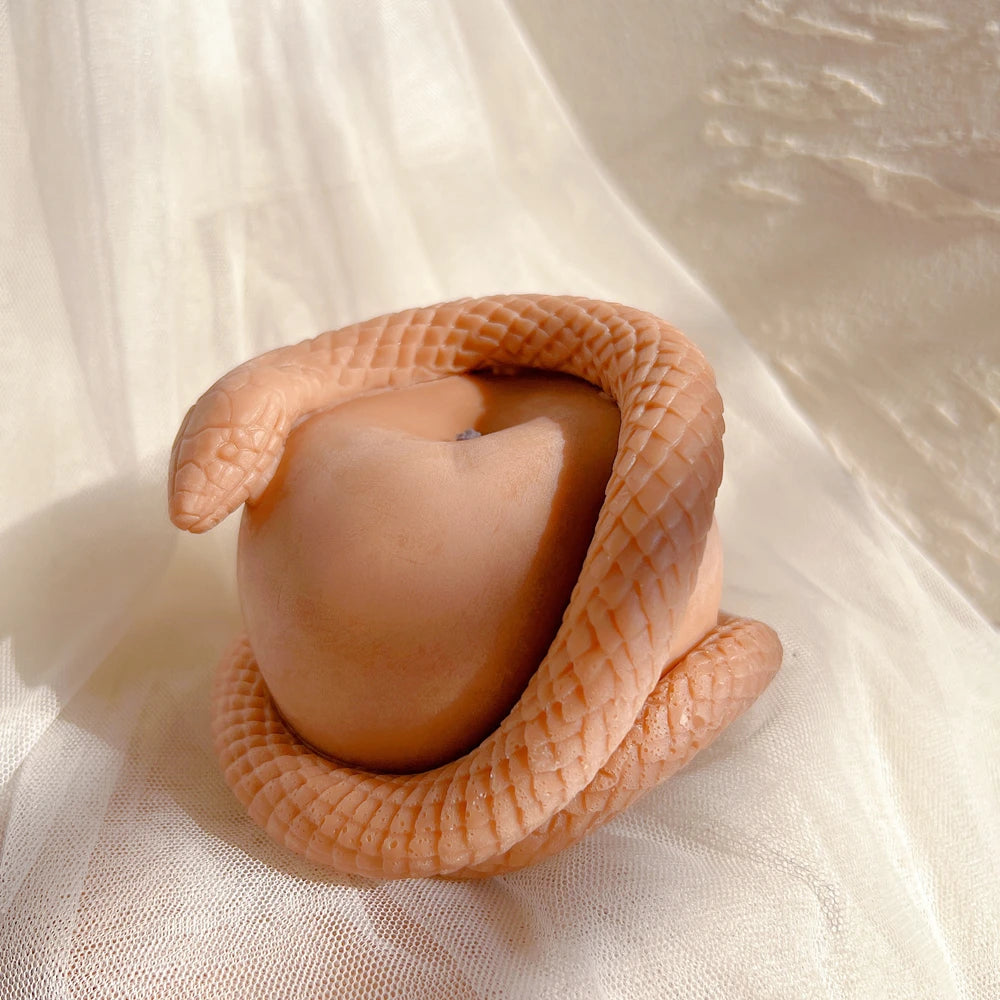 Angled view of the snake's head above the apple