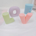 Angled display of green L, lilac O, peach V and blue E castings